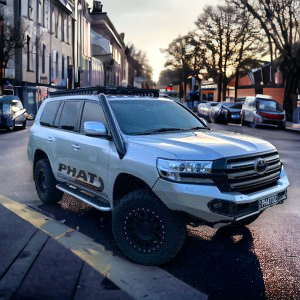 LandCruiser 200 Series 4-inch Phat Bars short-entry stainless snorkel installed on vehicle.