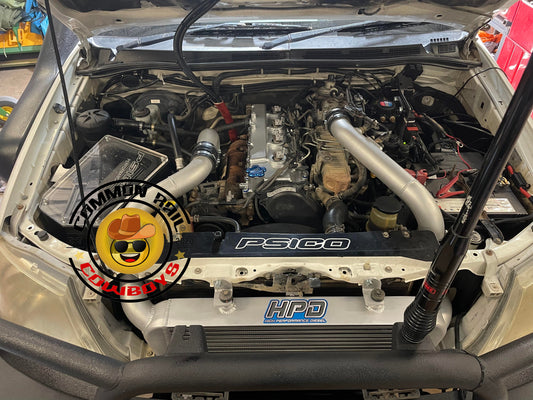 High Performance Diesel N70 Hilux Series 2 intercooler kit installed on a Toyota Hilux, showing the large intercooler core and piping.