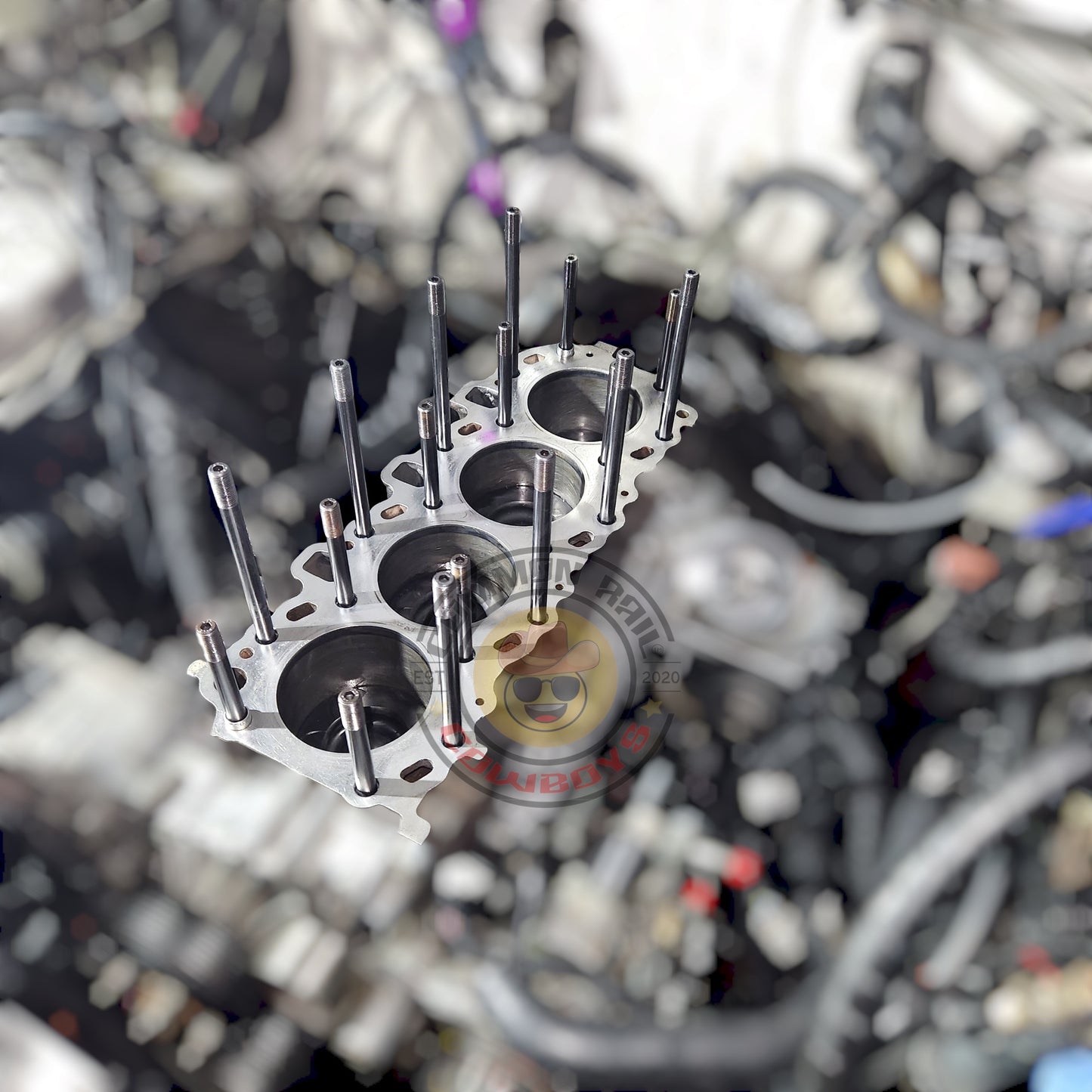 Diesel Performance Parts 1KD ARP head studs securely fasten engine components in a close-up image.