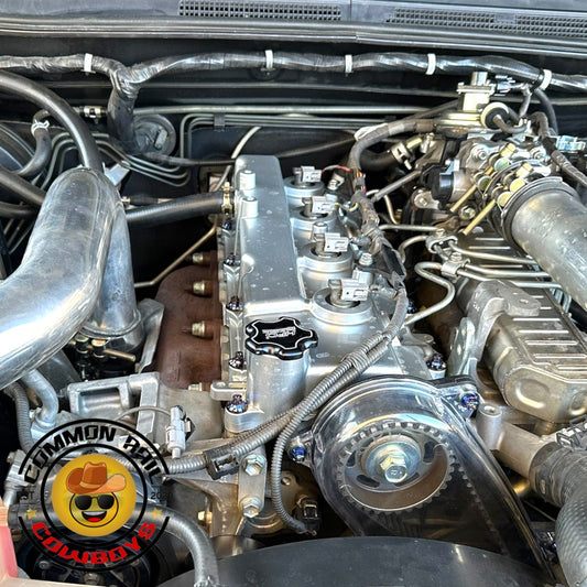 Toyota 1KD aluminium rocker cover by Common Rail Cowboys, showing the sleek, durable engine component with branding details.