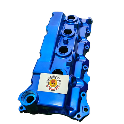 Colorful aluminium rocker cover for engine by Common Rail Cowboys, featuring a vibrant finish and detailed branding.