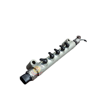 Toyota 1KD fuel rail for fuel pumps, part 23810-30100, shown in a detailed view with metal components and connectors.
