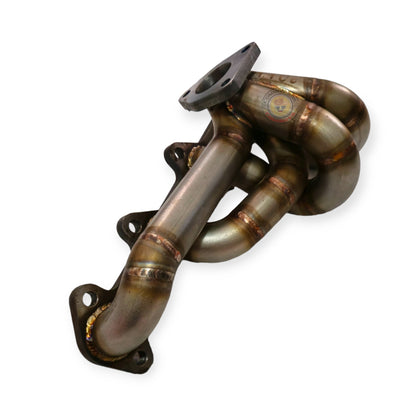 Toyota 1KD-FTV low mount exhaust manifold by PPRC, made of stainless steel, showing the detailed design and mounting points.