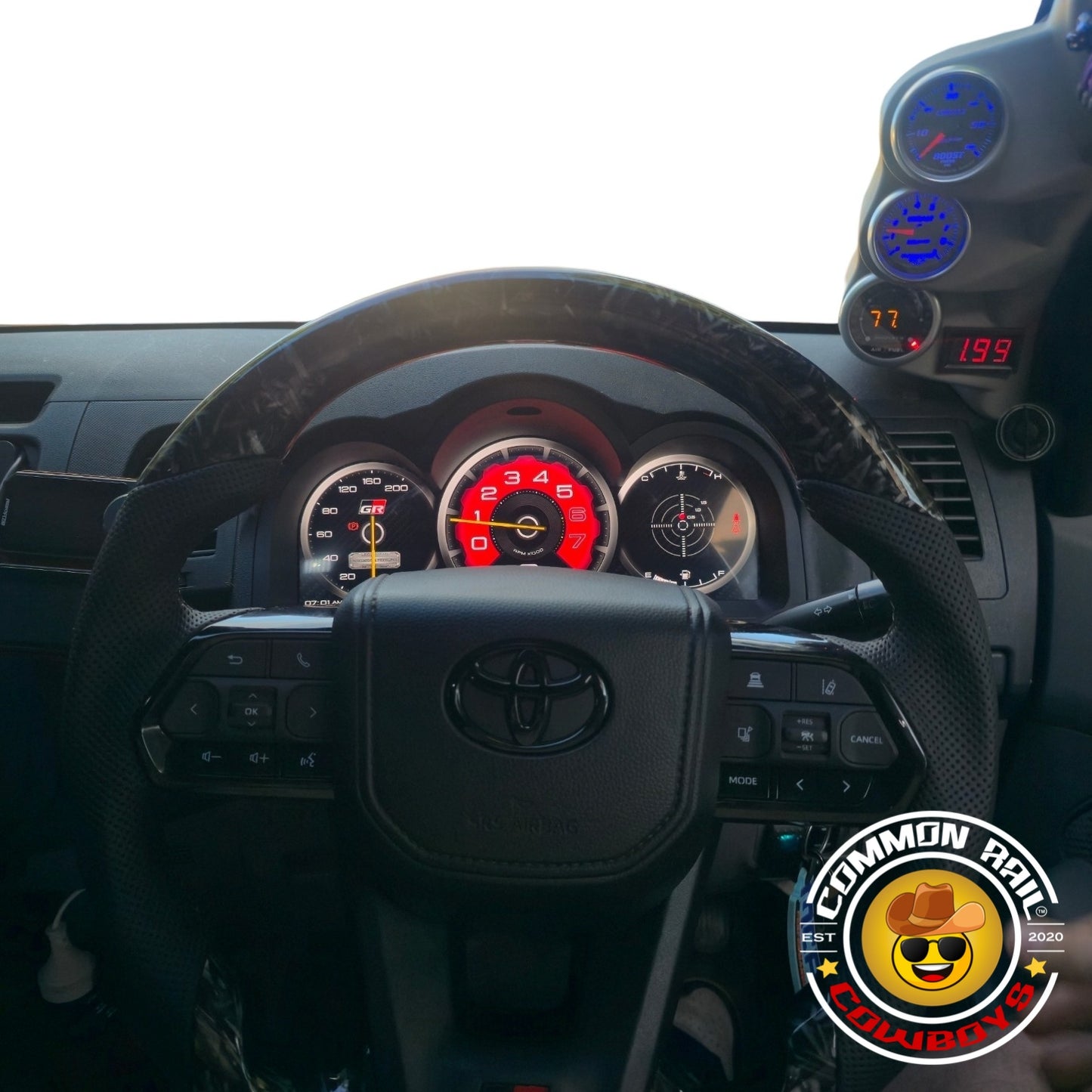 Hilux N70 digital dash display by Common Rail Cowboys showing a sleek digital instrument panel with speedometer and gauges.